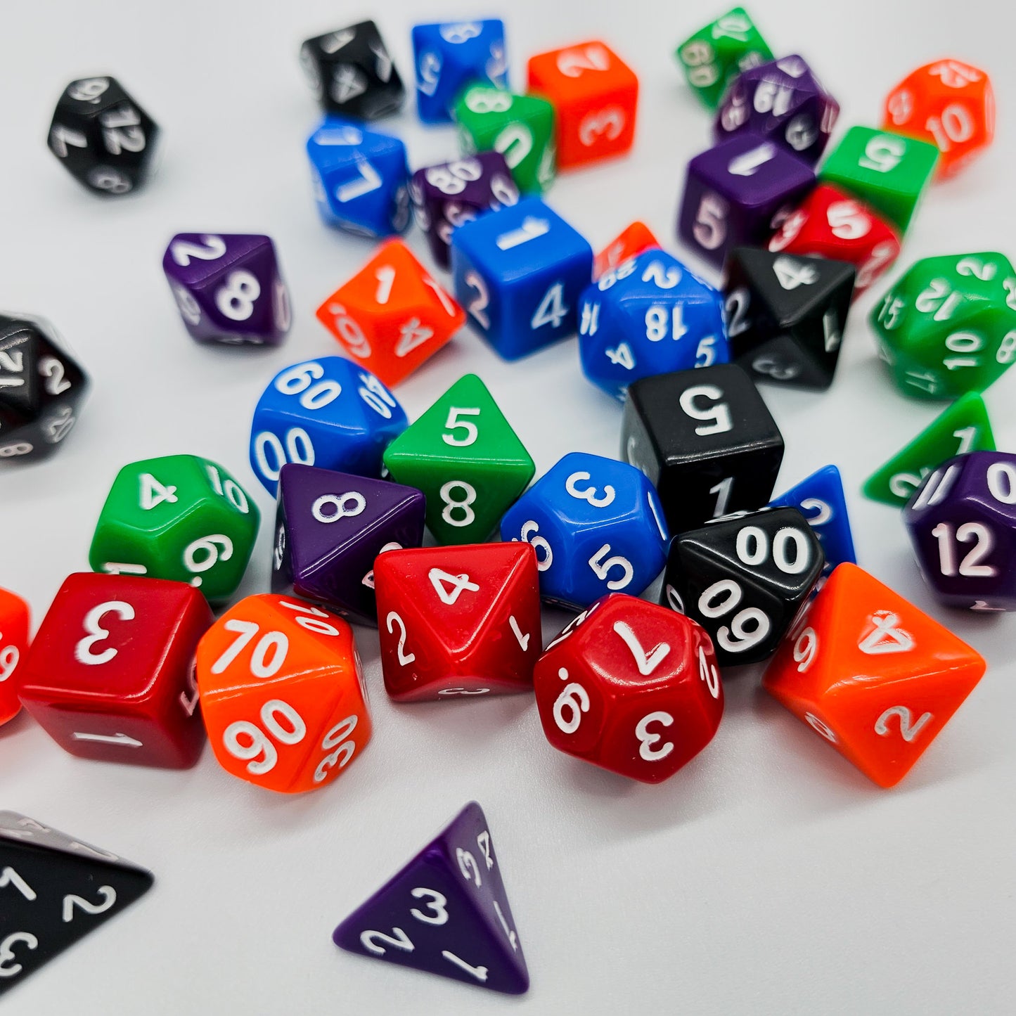 42 piece resin dnd dice set for 6 dungeon and dragons players. The dice colors are green, blue, red, purple, orange and black.