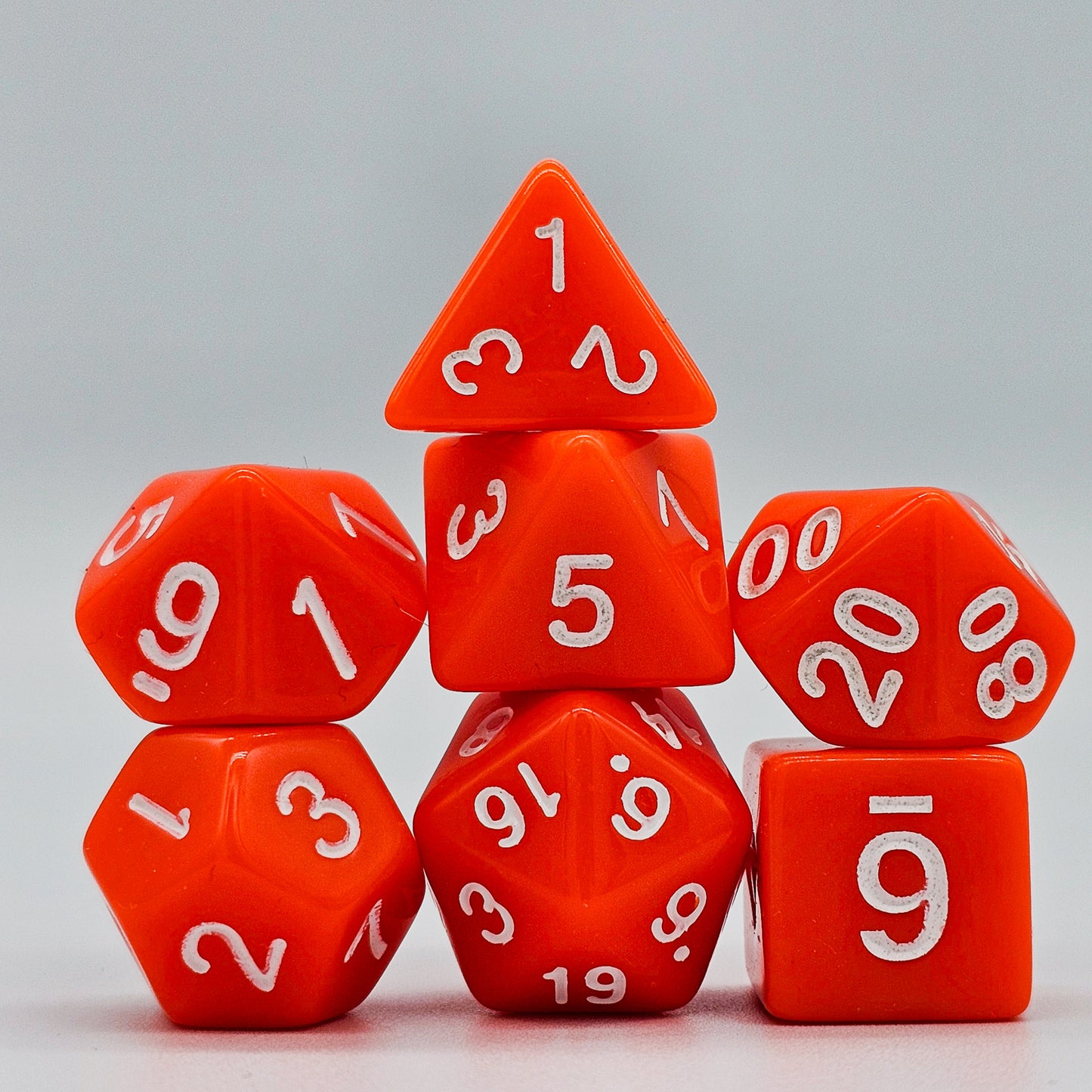 42 piece resin dnd dice set for 6 dungeon and dragons players. The dice colors are green, blue, red, purple, orange and black.