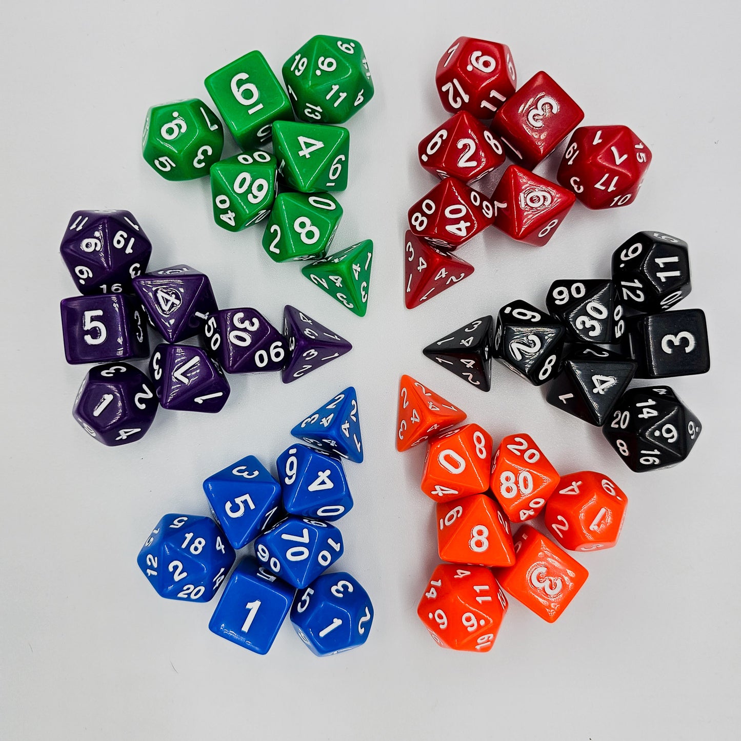 42 piece resin dnd dice set for 6 dungeon and dragons players. The dice colors are green, blue, red, purple, orange and black.