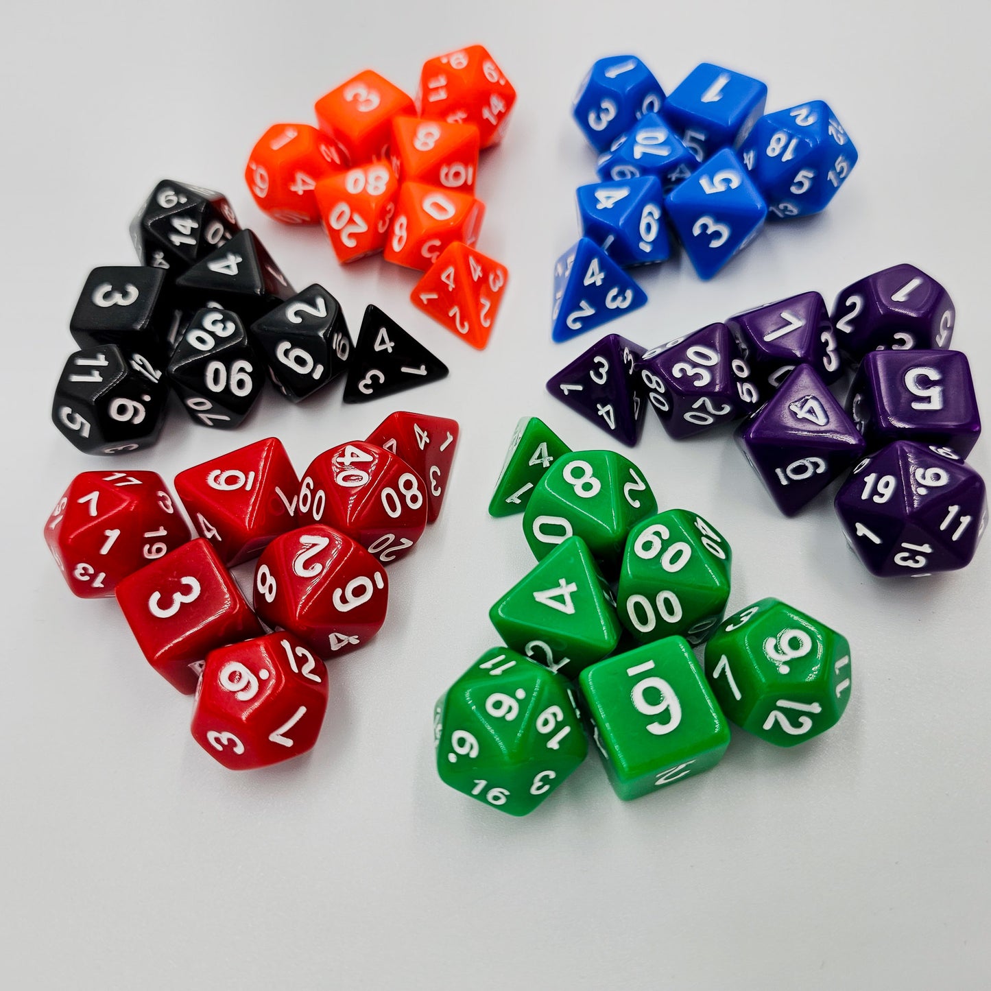 42 piece resin dnd dice set for 6 dungeon and dragons players. The dice colors are green, blue, red, purple, orange and black.
