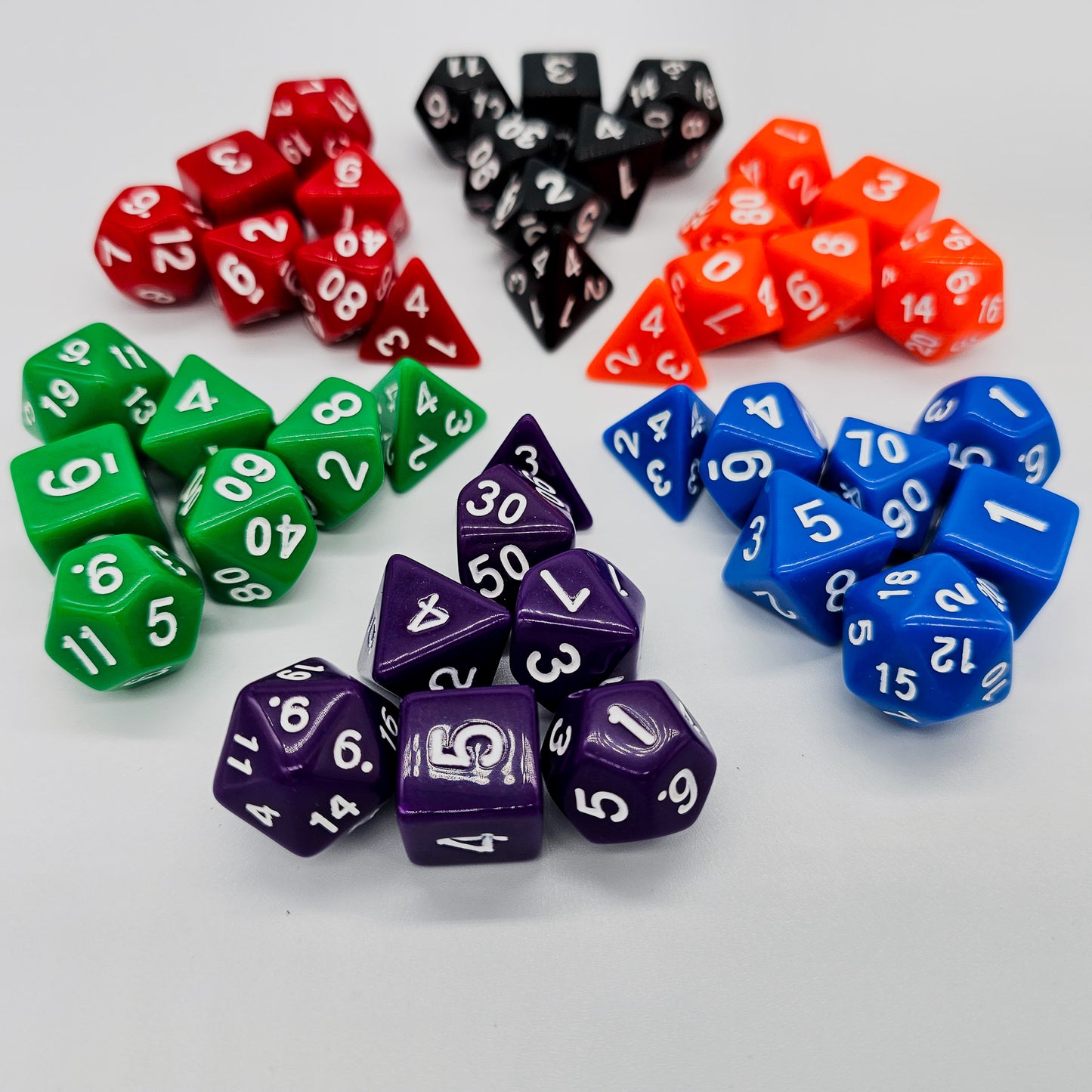 42 piece resin dnd dice set for 6 dungeon and dragons players. The dice colors are green, blue, red, purple, orange and black.