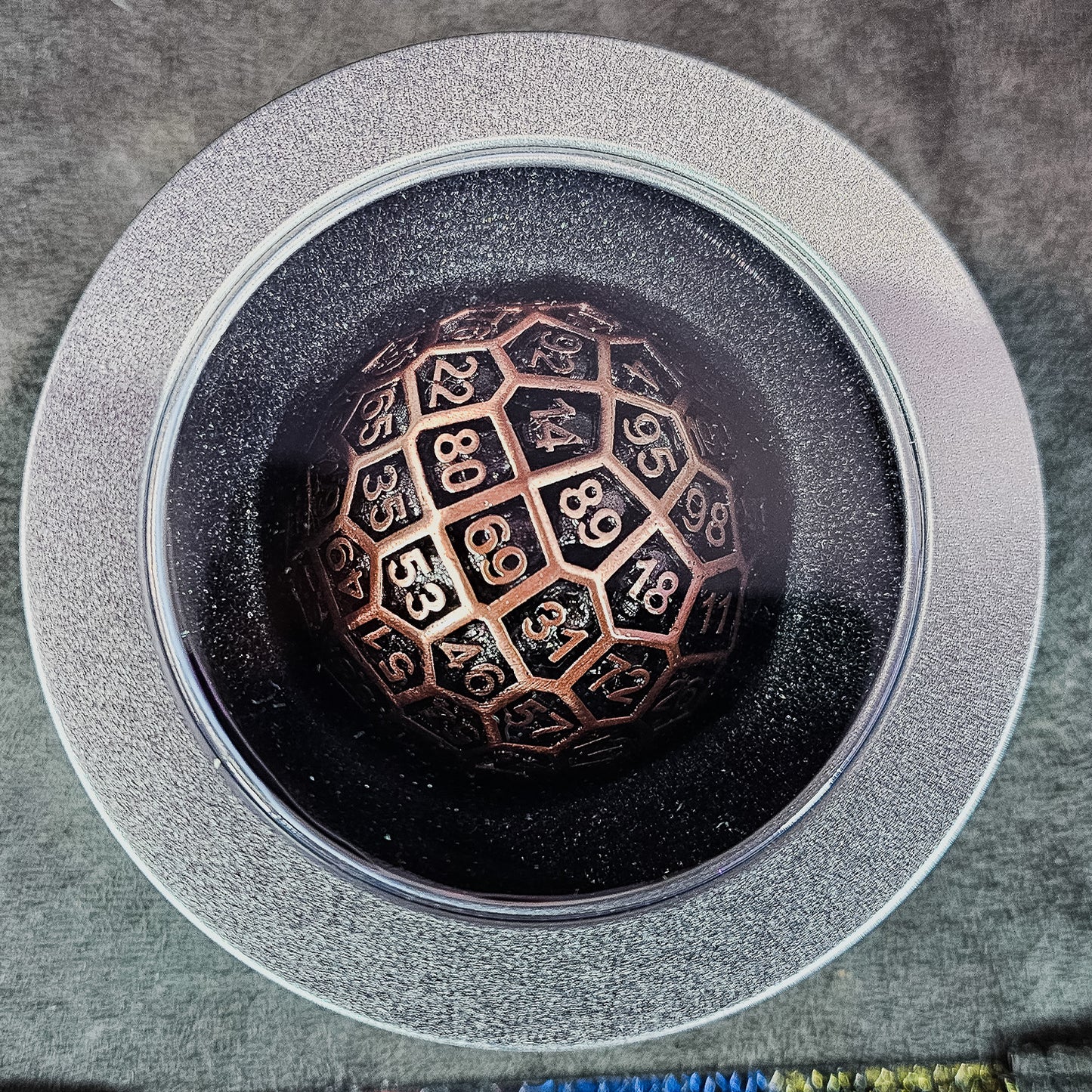 Red Copper Hollow Metal D100 DND Dice inside a silver metal spherical container with a plastic see through lid.