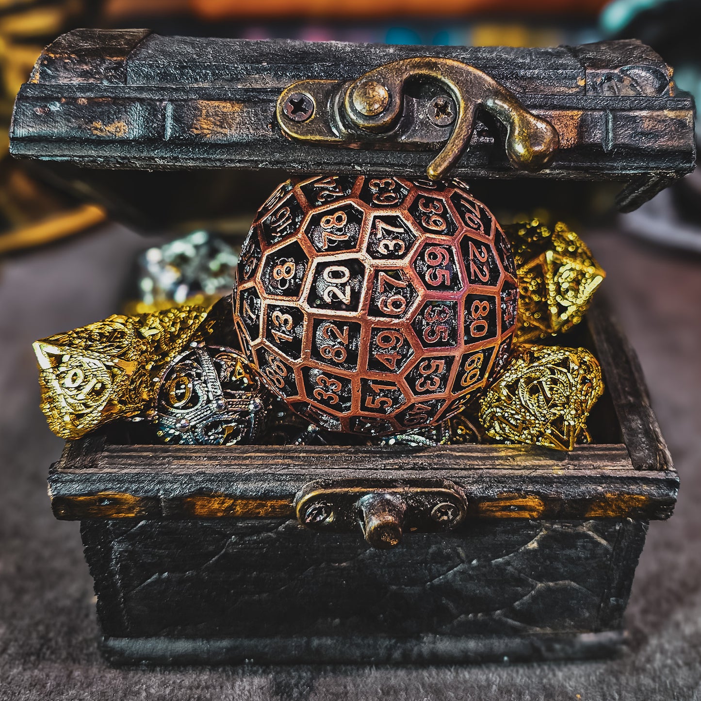 Red Copper Hollow Metal D100 DND Dice inside an opened treasure chest and surrounded by shiny gold and silver hollow metal dnd dice.