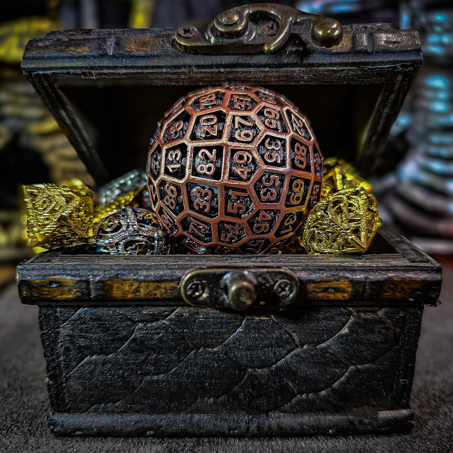 Red Copper Hollow Metal D100 DND Dice inside an opened treasure chest and surrounded by shiny gold and silver hollow metal dnd dice.