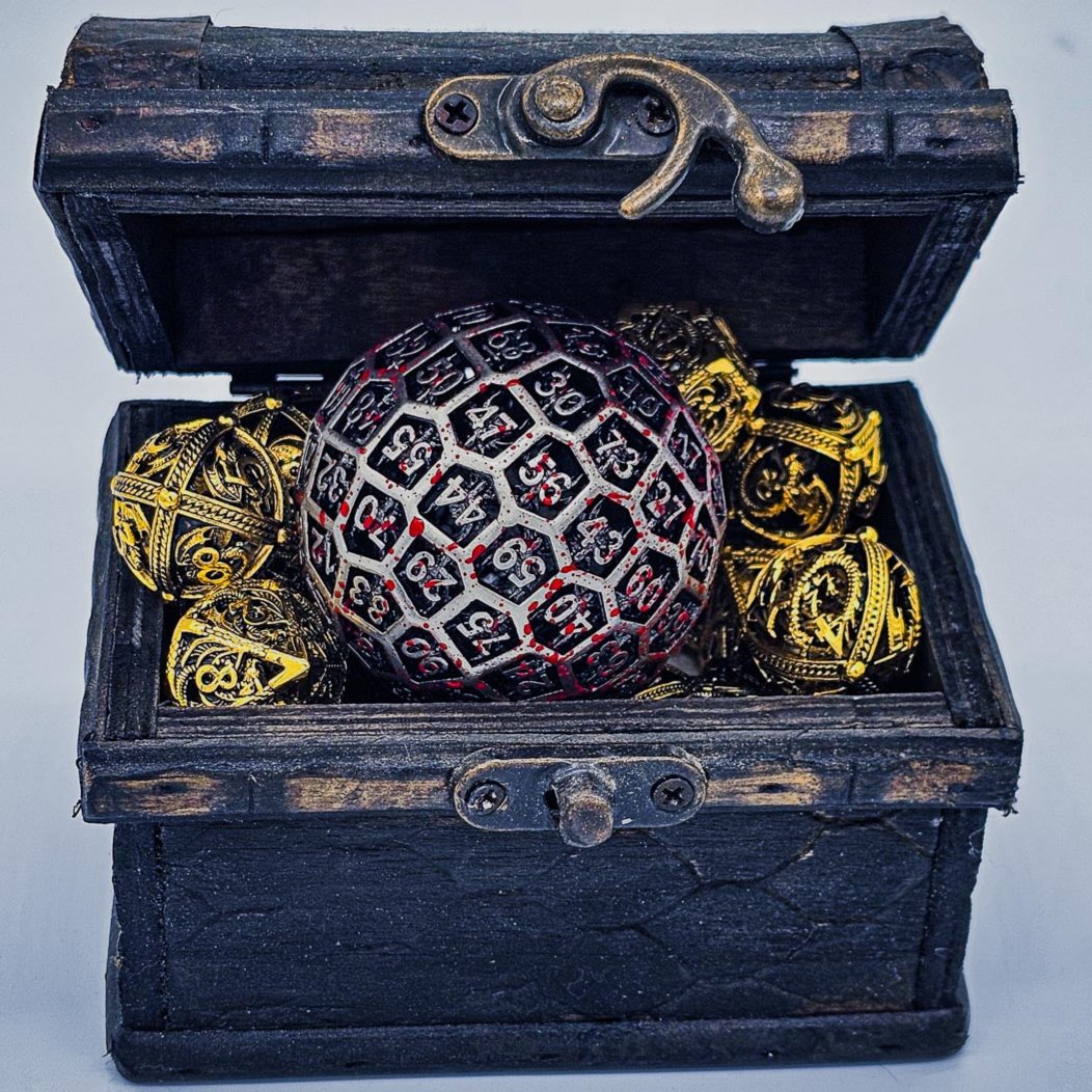 Hollow Metal Silver Blood D100 DND Dice inside a treasure chest full of shiny gold hollow metal DND Dice.