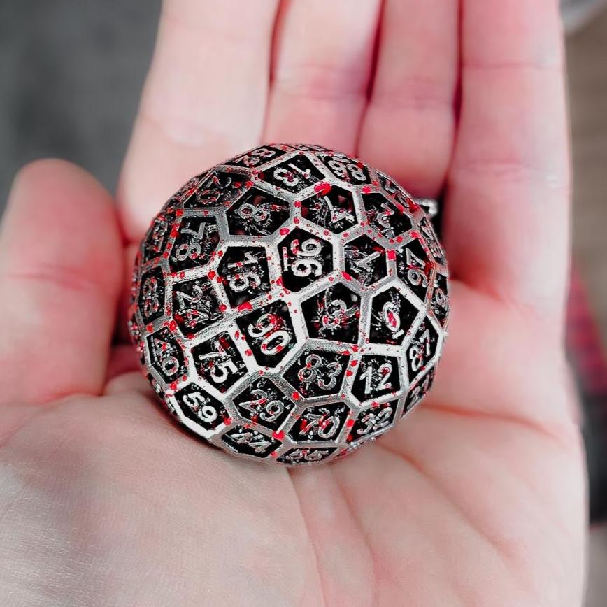 Hollow Metal Silver Blood D100 DND Dice in the palm of a persons hand.