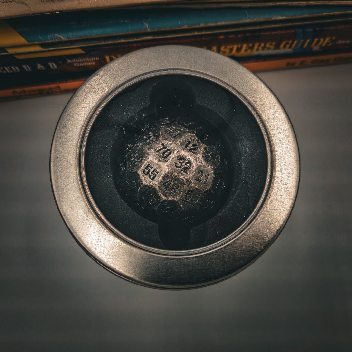 Metal Silver D100 DND Dice inside a silver metal container with a plastice see through window on the lid.