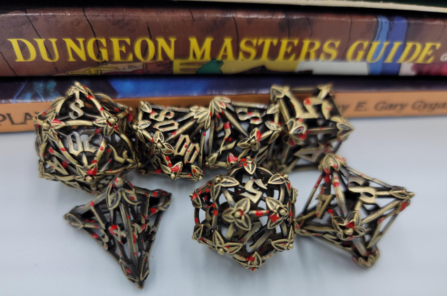 Ancient Gold w/ Blood Splatter Hollow Metal Caltrops Dice