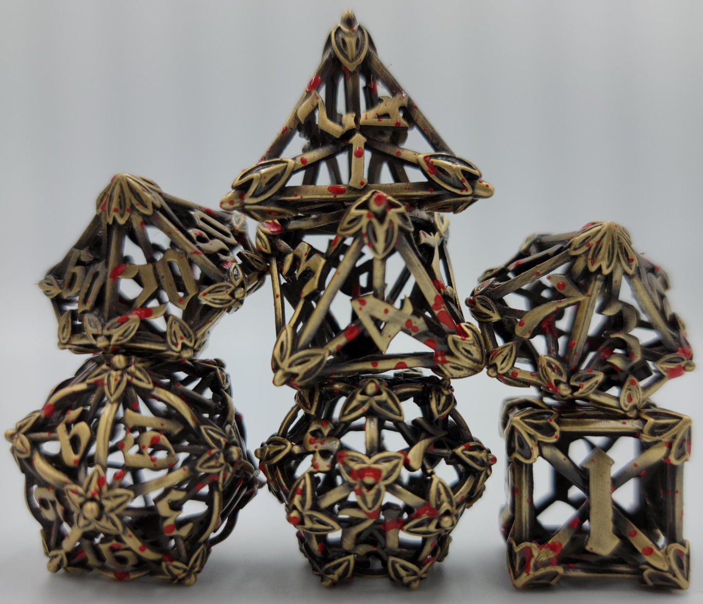 Ancient Gold w/ Blood Splatter Hollow Metal Caltrops Dice