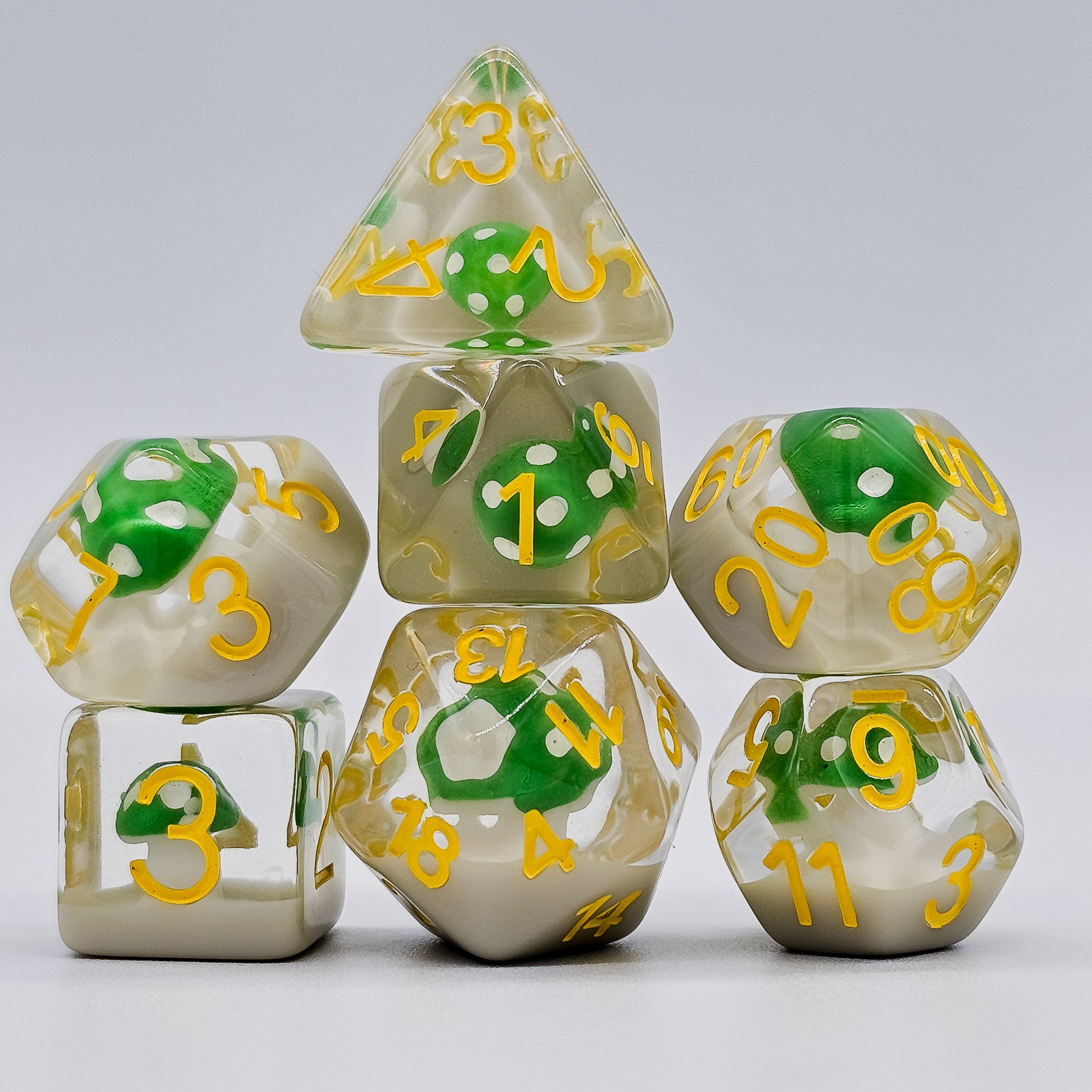 Transparent resin DND Dice with green mushrooms inside stacked up.