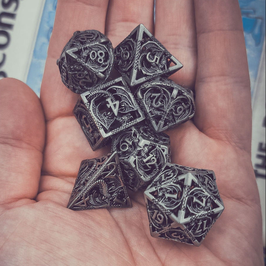 Hand holding six polyhedral dice with a Dungeons & Dragons book in the background