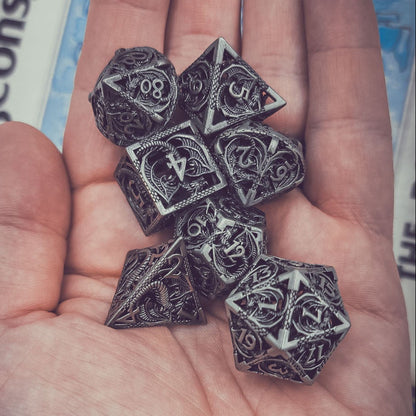 Hand holding six polyhedral dice with a Dungeons & Dragons book in the background