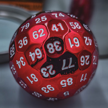 Close up shot of a Red Solid Metal D100 DND Dice